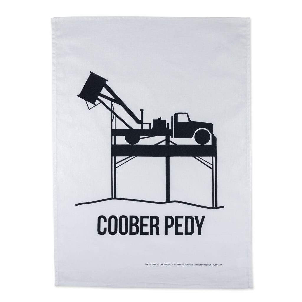 black and white tea towel with tractor with text reading coober pedy 