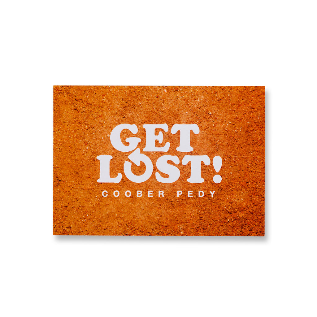 orange post card with words get lost coober pedy 