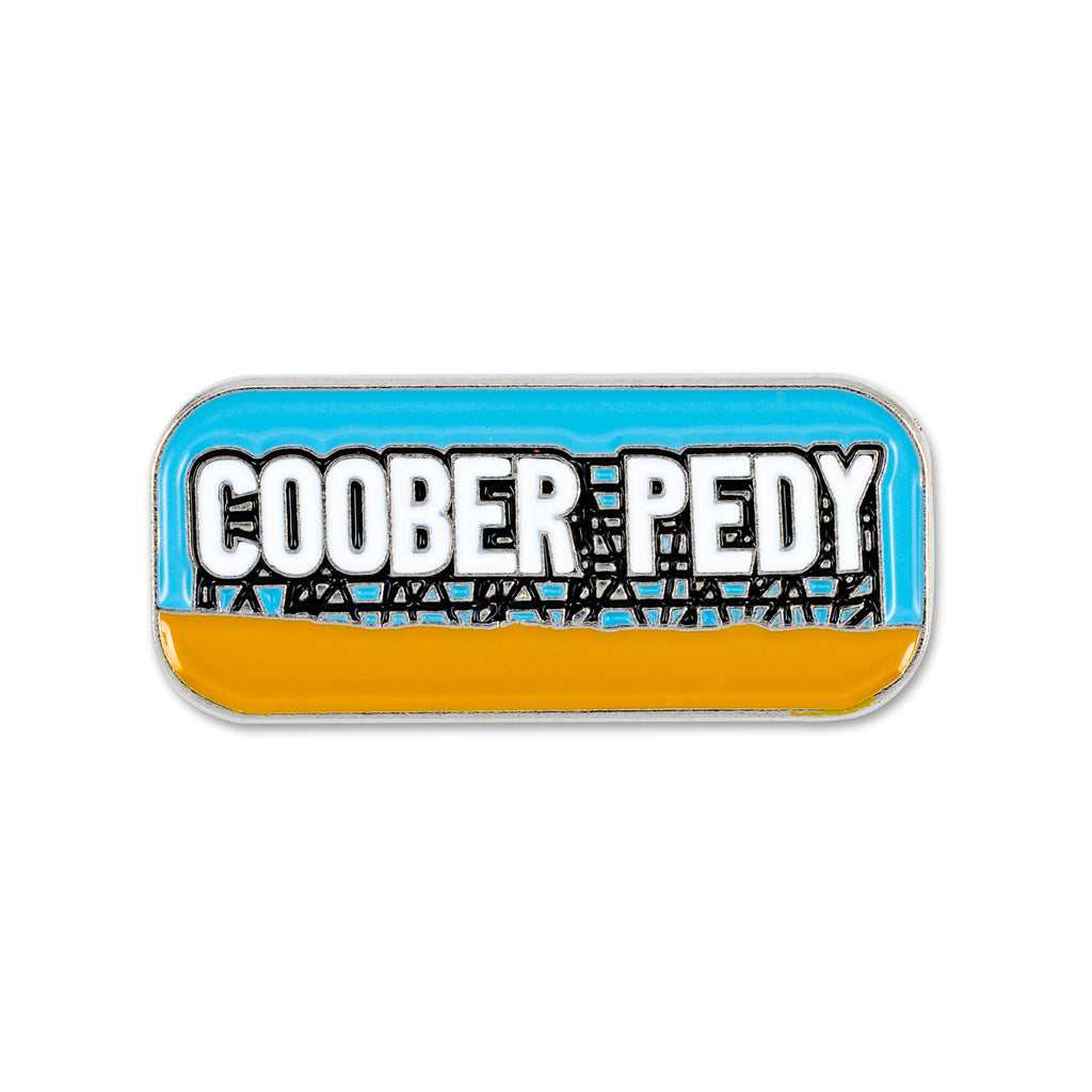 rectangular lapel pin orange and blue reading coober pedy 