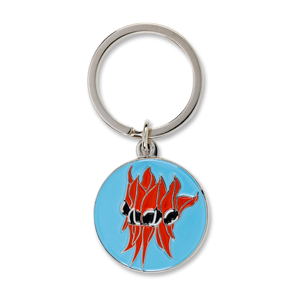 blue and red round keyring with image of sturt desert pea 
