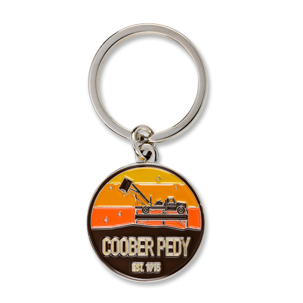 yello and brown key ring reading coober pedy 